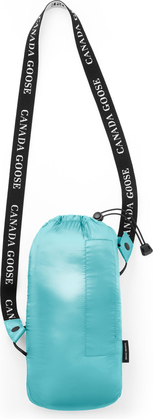A light blue cinch-top bag hangs from a black strap with repeating white text reading "CANADA GOOSE".