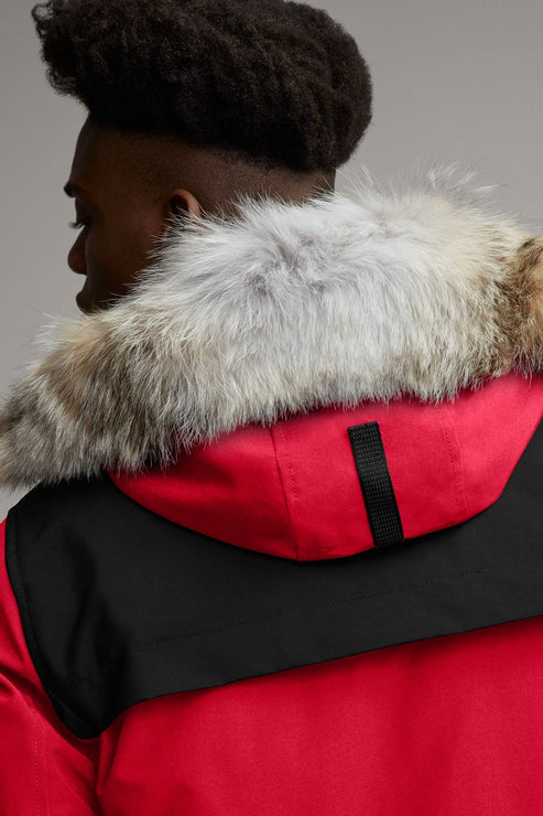 Red and black hooded jacket with fur trim seen from the back