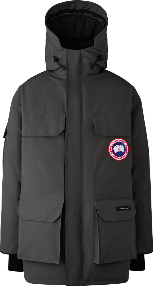 Gray parka jacket with four large front pockets and a circular emblem on the left breast.