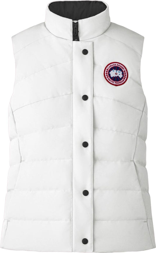 White quilted vest with black lining and round logo patch on chest.