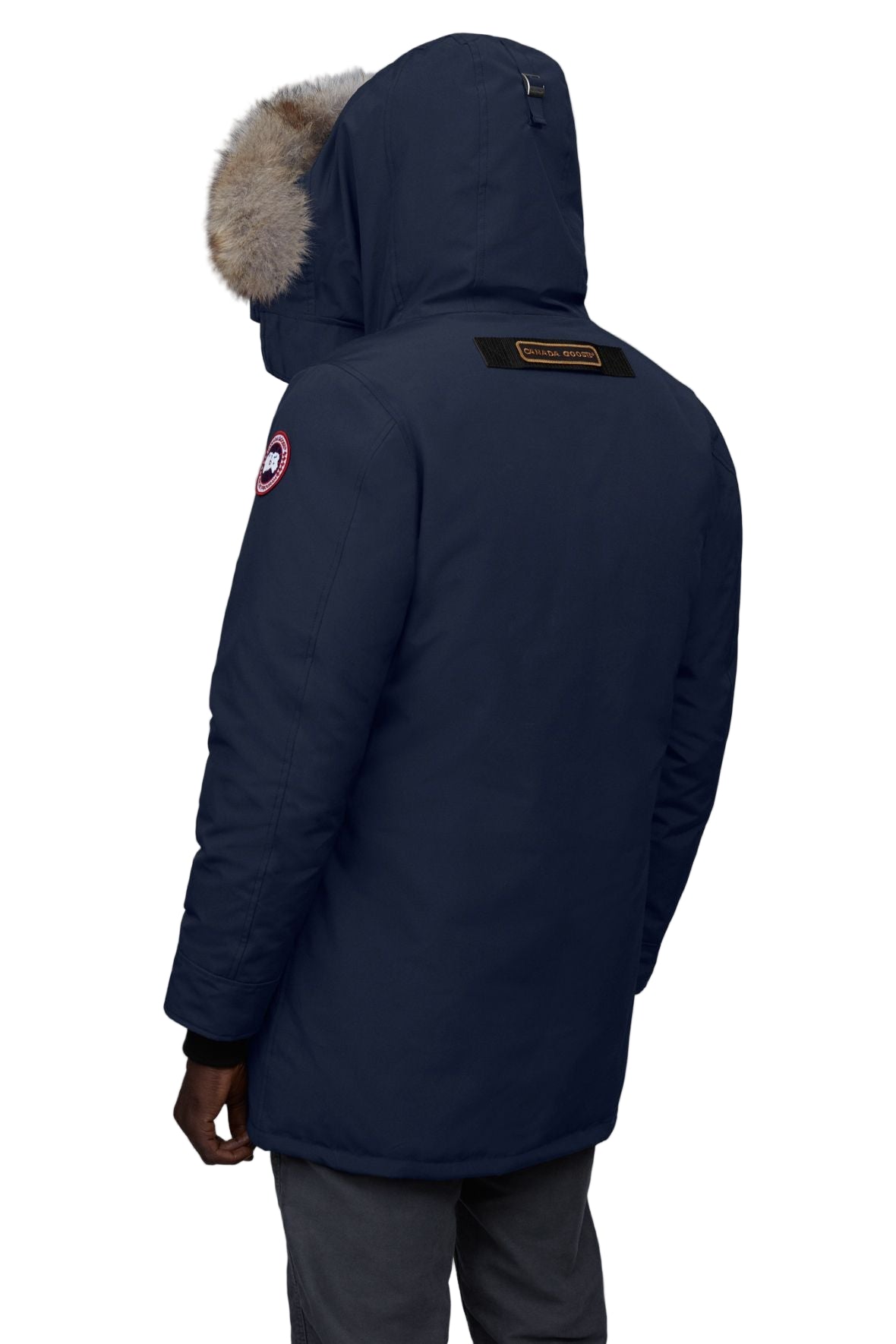 Back view of a navy parka with a fur-trimmed hood and a logo on the shoulder.