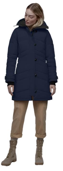 A woman in a navy coat, khaki pants and matching boots.