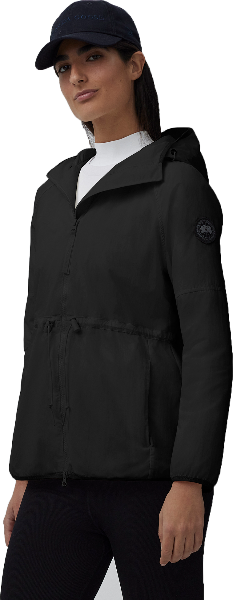 A woman in a black jacket and dark blue hat.