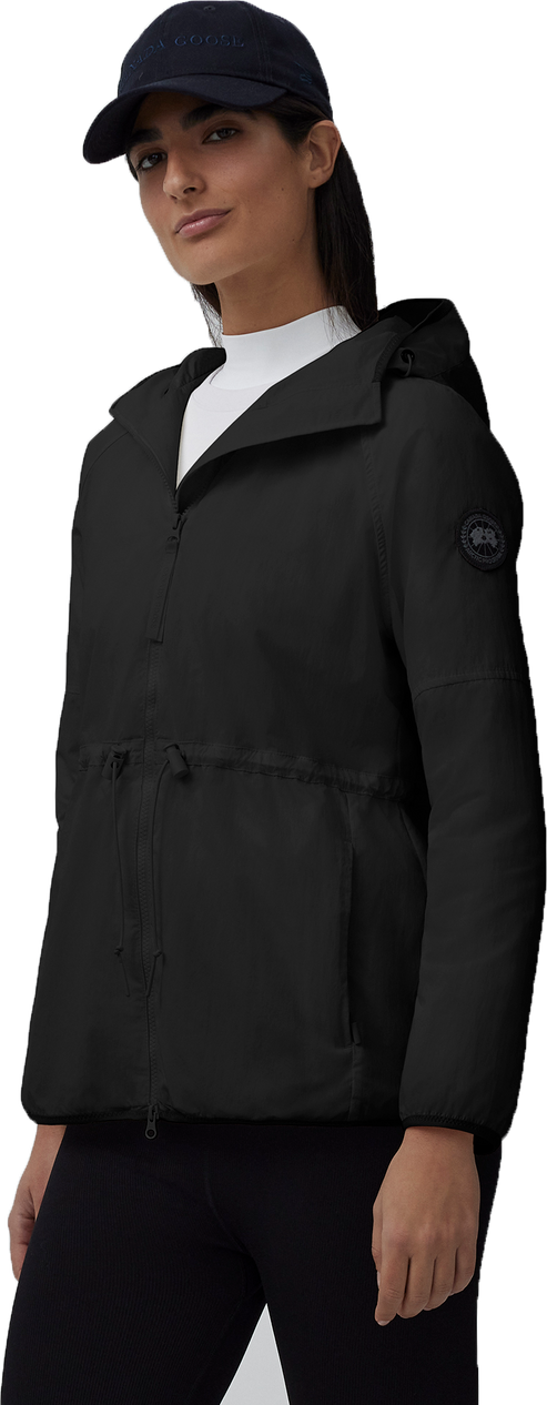 A woman in a black jacket and dark blue hat.