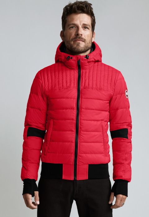 A red down jacket with a hood, black accents on the sleeves, bottom, and zipper.