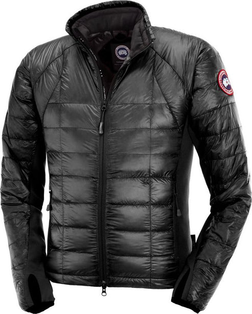 A puffy, black jacket with a round logo on the left shoulder, a full zipper in the front, and thumb holes on the sleeves.
