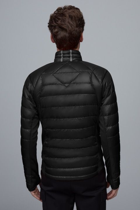 Back view of a quilted black jacket with a stand-up collar and horizontal stitching.