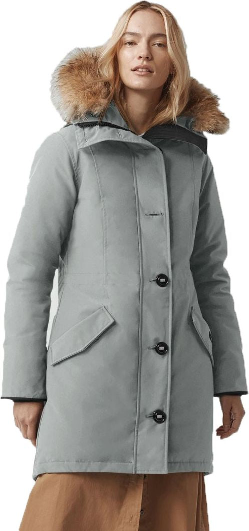 A woman wearing a gray parka with fur trim.