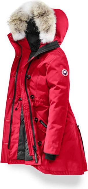 A red parka with a fur-trimmed hood is unzipped to reveal a black interior lining.