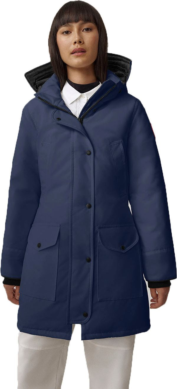 A woman wearing a navy parka with a black hood.