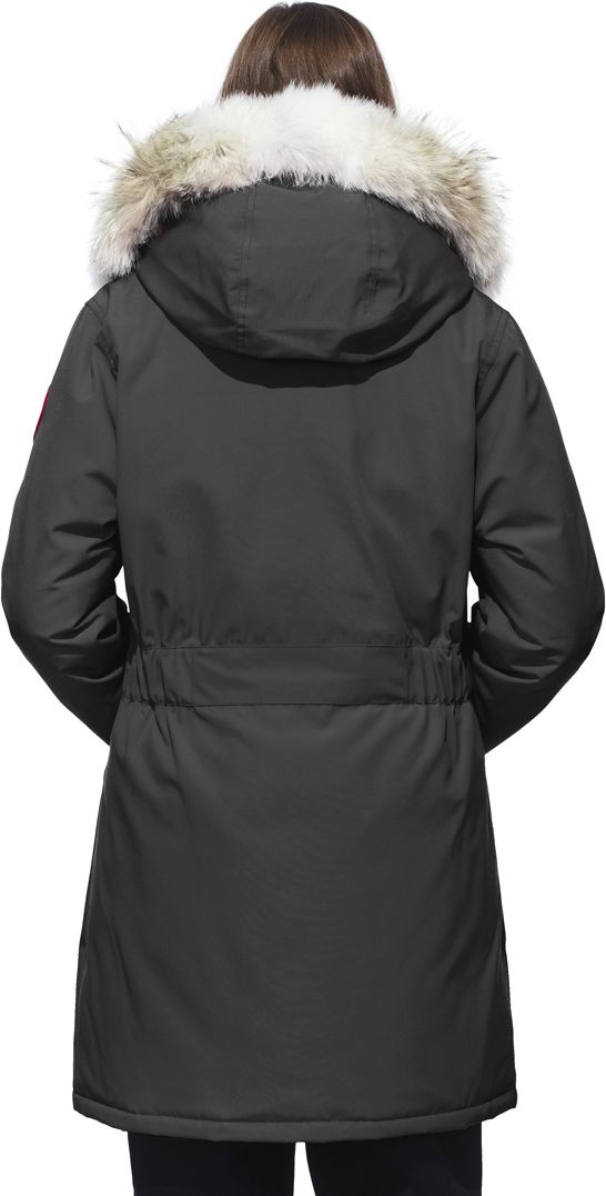 A woman wearing a black hooded winter coat with a white fur trim.