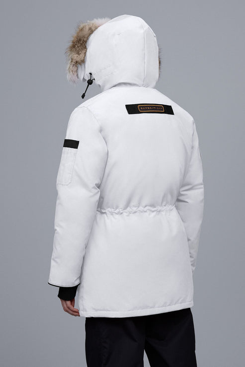 White parka with fur-lined hood and black logo patch on the back
