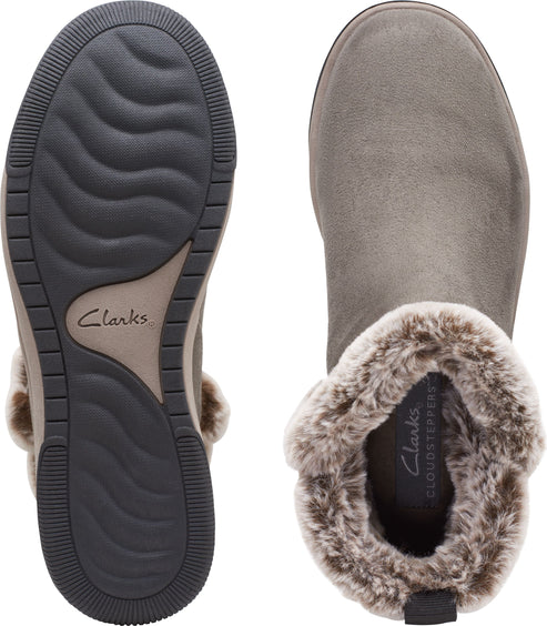 Top-down view of light gray ankle boots featuring fur trim and the word Clarks on the sole.