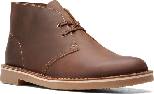 Brown leather chukka boot with tan sole and brown laces.