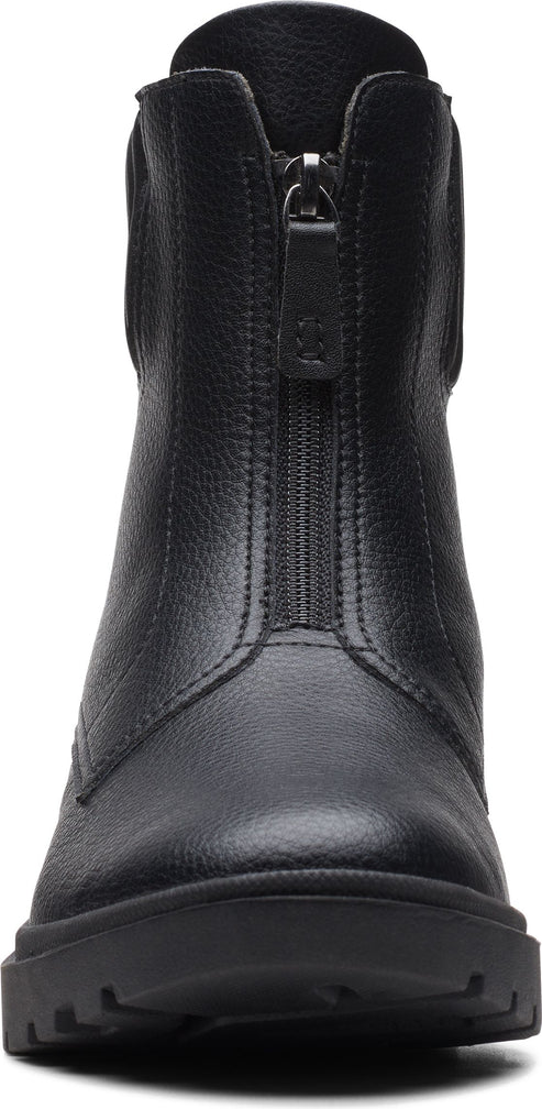 A close-up of a black, zip-up boot.