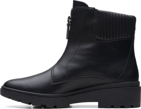 Black ankle boot with textured upper and front zipper.