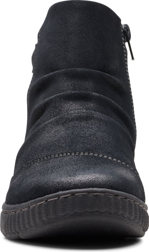 Front view of a scrunched, black suede ankle boot with side zip and textured rubber sole.