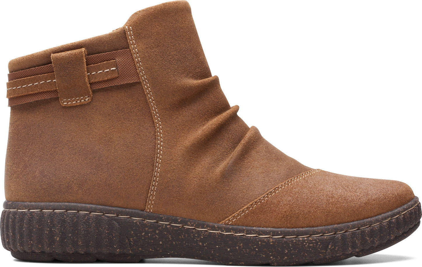 Tan ankle boot with a low, textured sole and decorative straps.