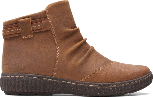 Tan ankle boot with a low, textured sole and decorative straps.