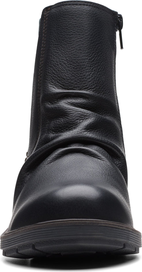 Close-up of a black ankle boot with a side zipper.