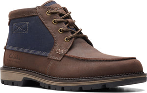 Brown leather ankle boot with a moc toe, brown laces, metal eyelets, a dark blue canvas shaft and a lug sole.