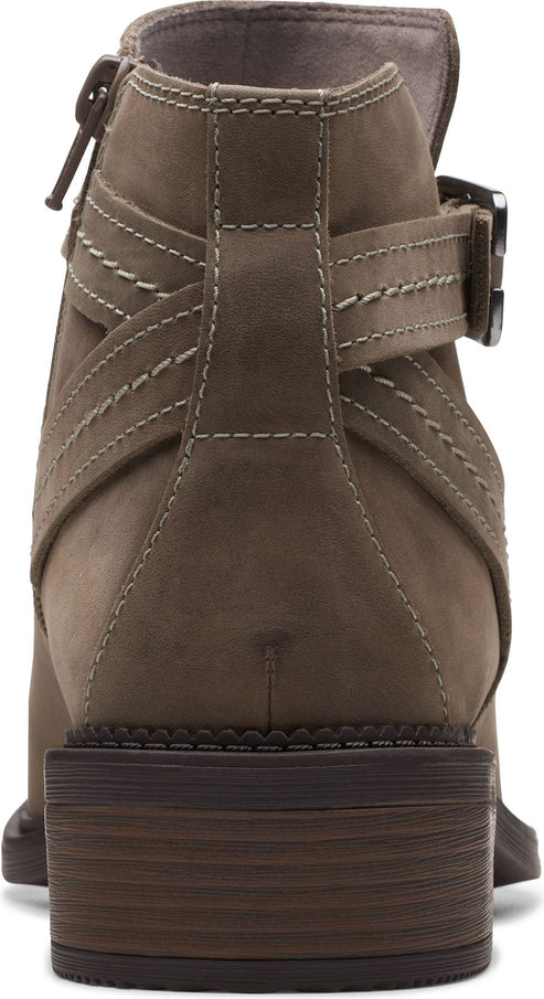 Back view of an ankle boot in taupe with a stacked heel, decorative buckle, and stitching.
