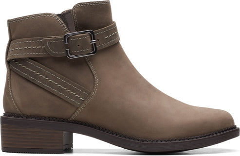 Ankle-high, taupe-colored boot with a side buckle and decorative stitching.