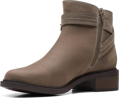 Leather ankle boot with side zipper and strap detail.