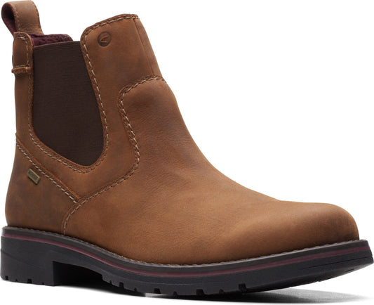A light brown, ankle-high Chelsea boot with elastic side panels and a pull tab on the back.