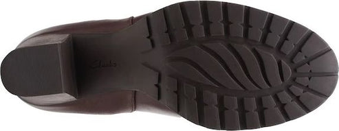 Brown boot outsole with tread.