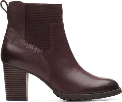 Dark red, high-heeled leather boot with an elastic upper and a lug sole.
