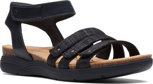 Black sandal with three straps, cork sole and adjustable ankle strap.