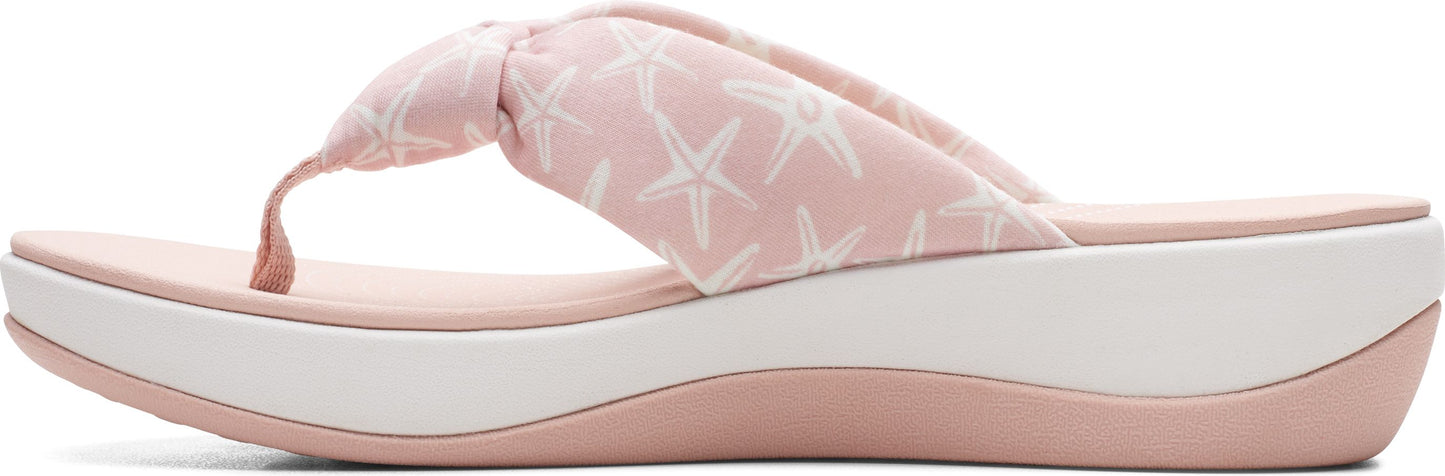 Pink platform sandal with starfish pattern.