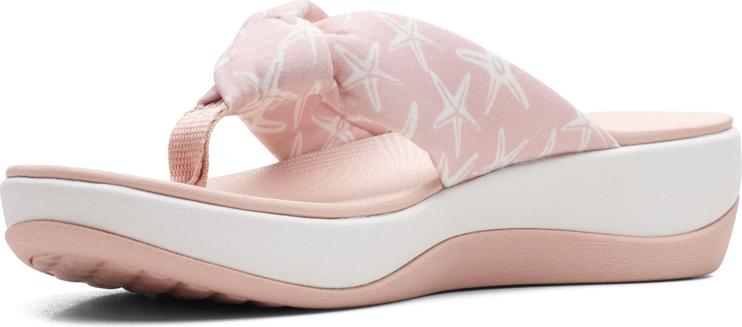 A pink platform sandal with starfish print.