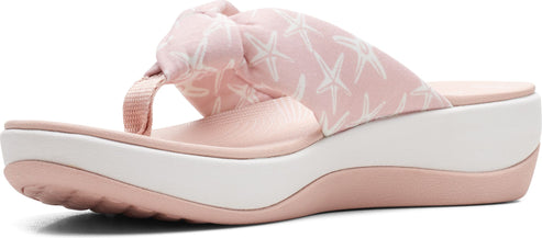 A pink platform sandal with starfish print.
