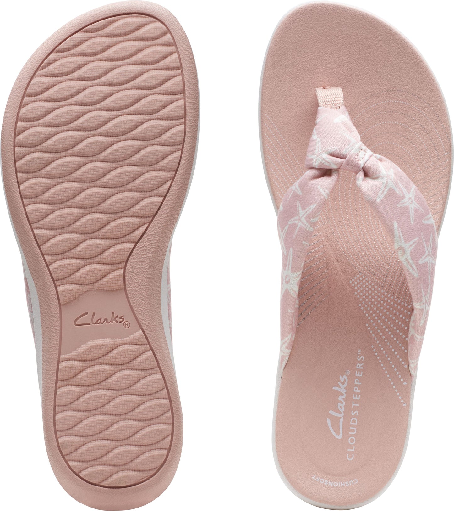 Pink flip flops with starfish pattern, showing insole and sole.