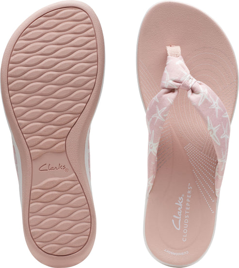 Pink flip flops with starfish pattern, showing insole and sole.