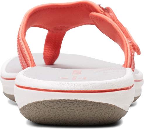 Peach sandals with white sole and gray grip seen from behind.
