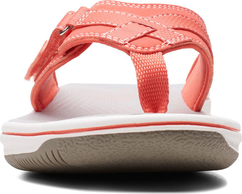 Coral sandal with woven straps, toe post, and adjustable velcro strap.