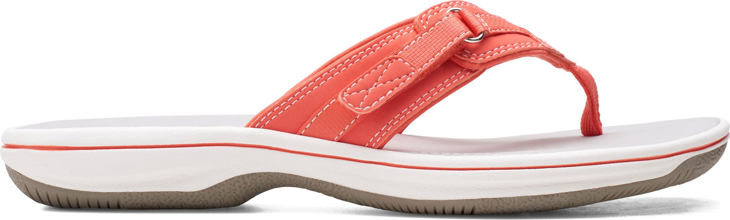 A salmon-colored sandal with white sole and gray bottom.
