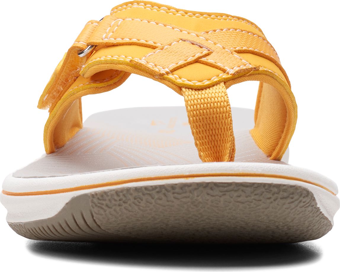 Yellow thong sandal with criss-cross straps.