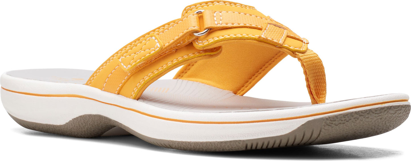 A yellow sandal with a flat heel.