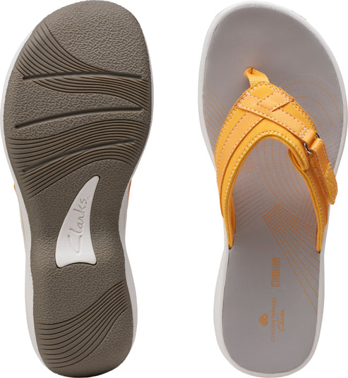 Pair of flip-flops: gray footbed and white midsole; dark brown sole with wavy treads; yellow straps.