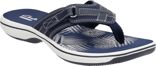 A navy blue sandal with a white sole and a strap.