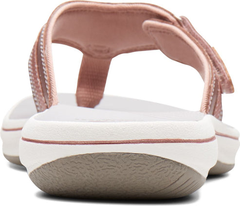 Rear view of pink women's sandal with t-strap and white sole.