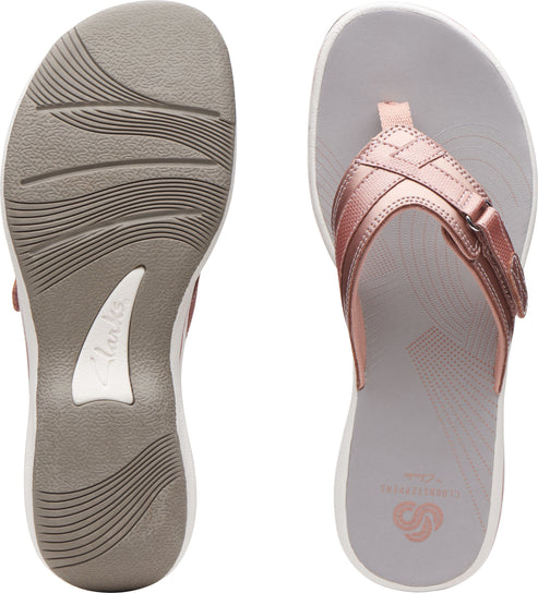 A pair of pink strappy flip-flops. The left shoe shows the ridged sole and the right shoe shows the insole.