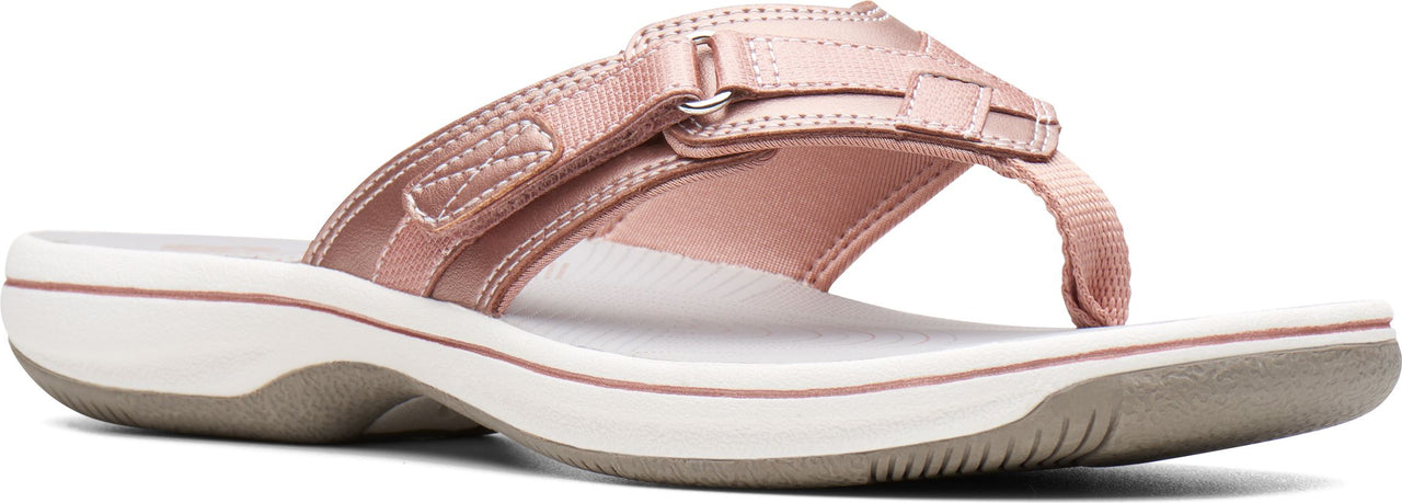 A pink sandal with a white sole.