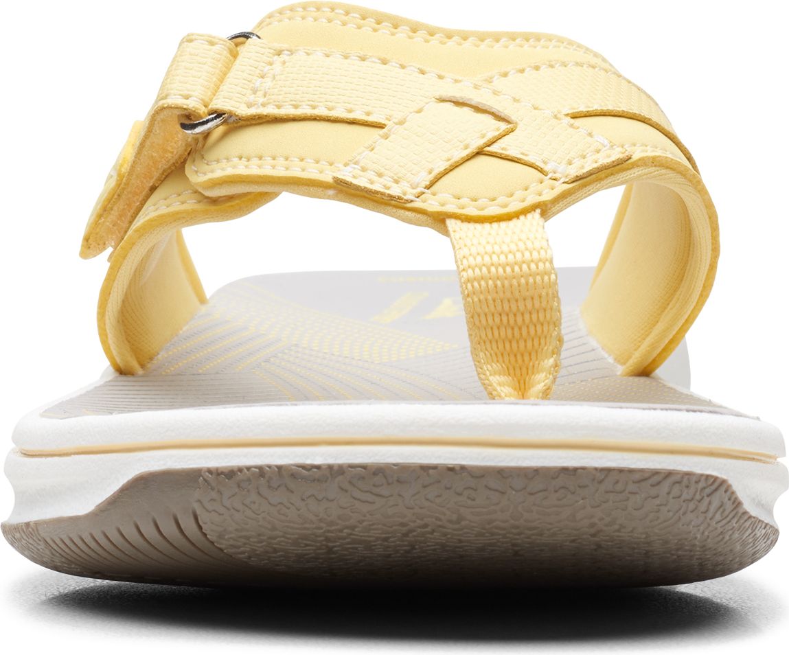 Yellow toe thong sandal with adjustable velcro strap.