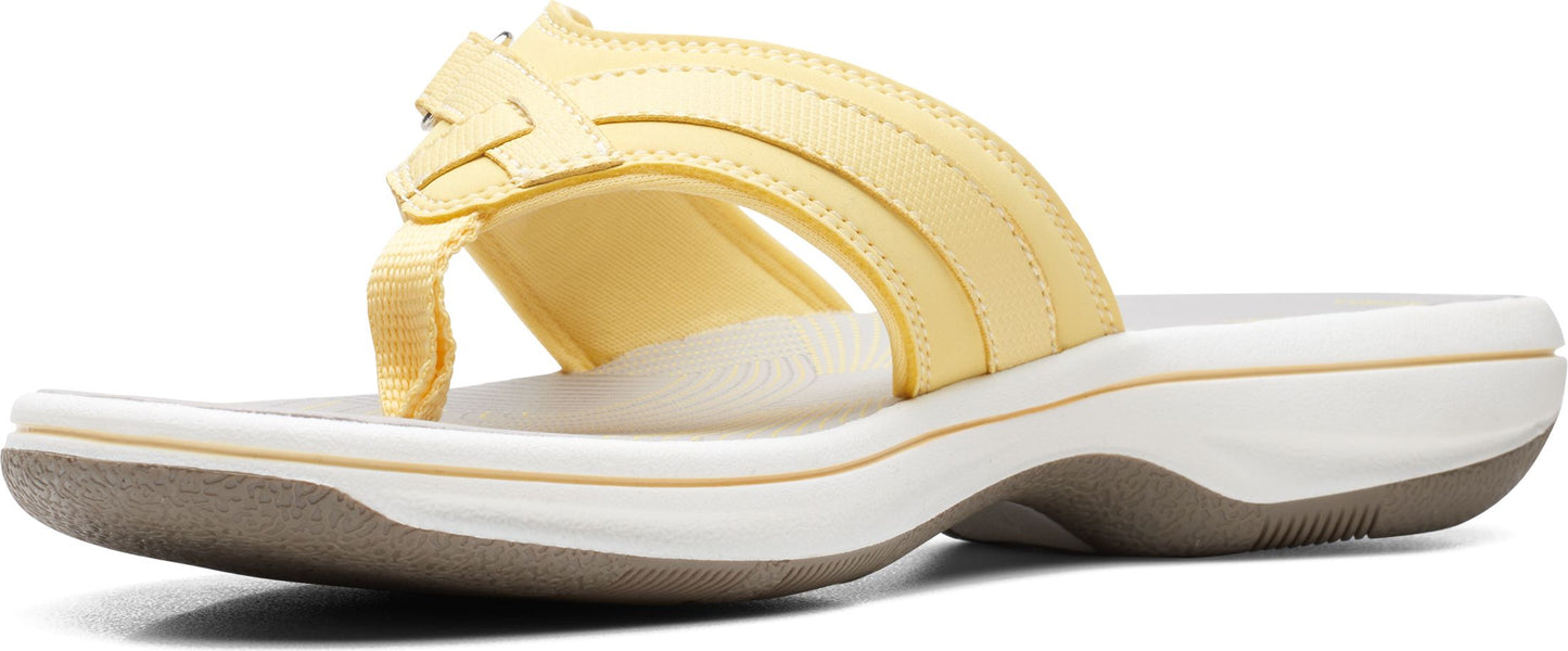 A yellow sandal with straps.