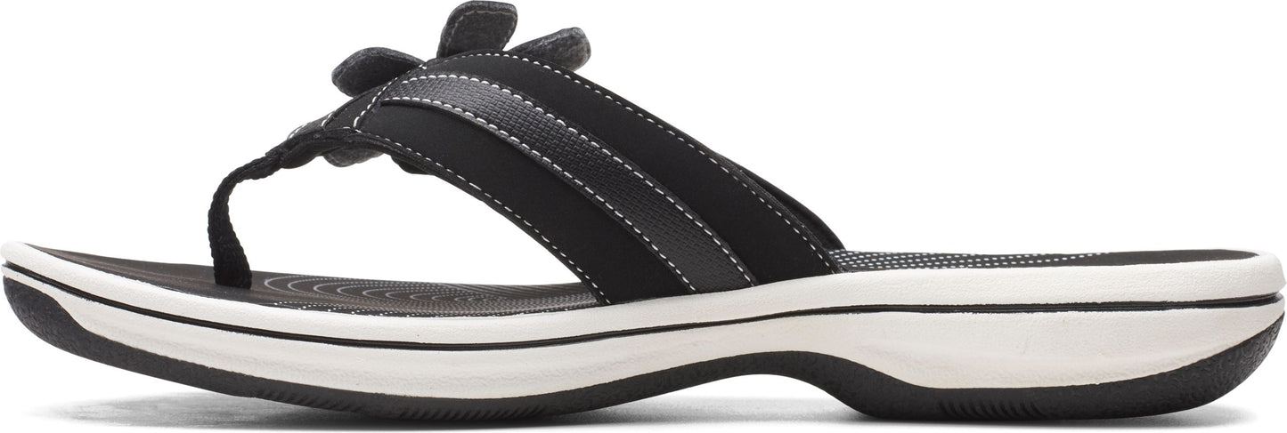 A black sandal with a flower on the upper.